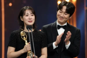 Elegant Korean awards ceremony with actors celebrating a major acting prize