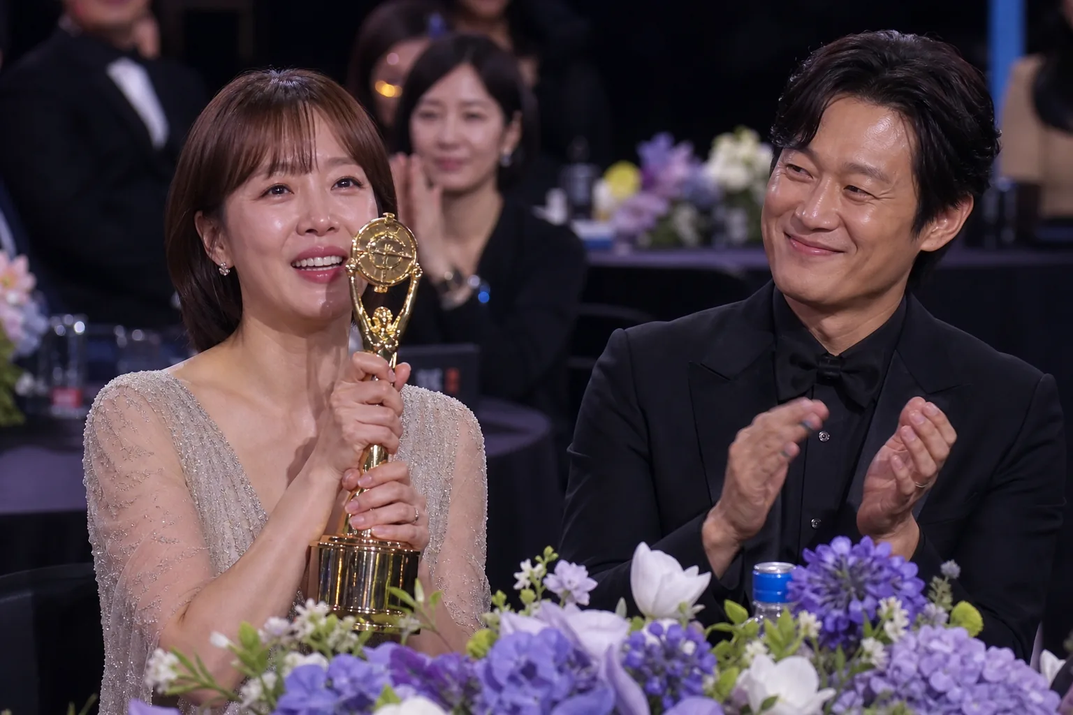 Supportive couple celebrating a career milestone at a formal event