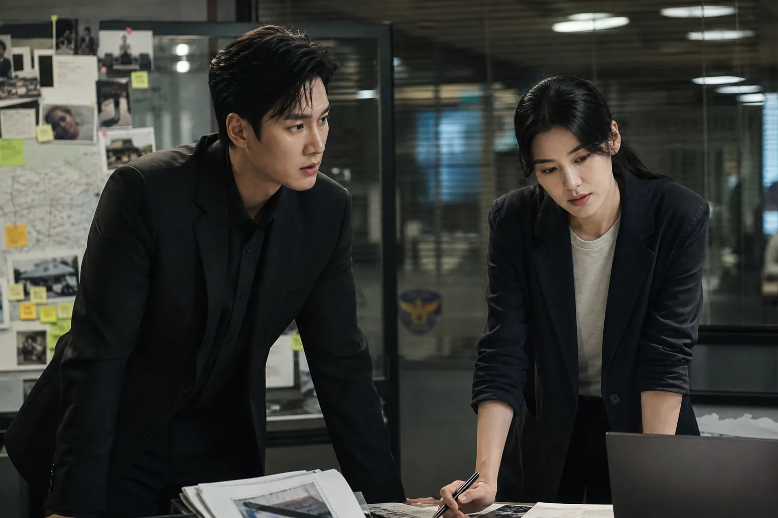 Detectives reviewing evidence in a modern investigation room