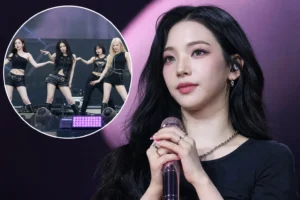 K-pop girl group performing on a large outdoor festival stage at night