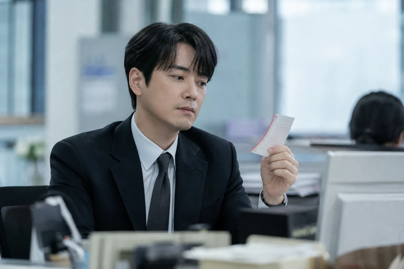 Korean office worker reflecting after an unexpected lottery win