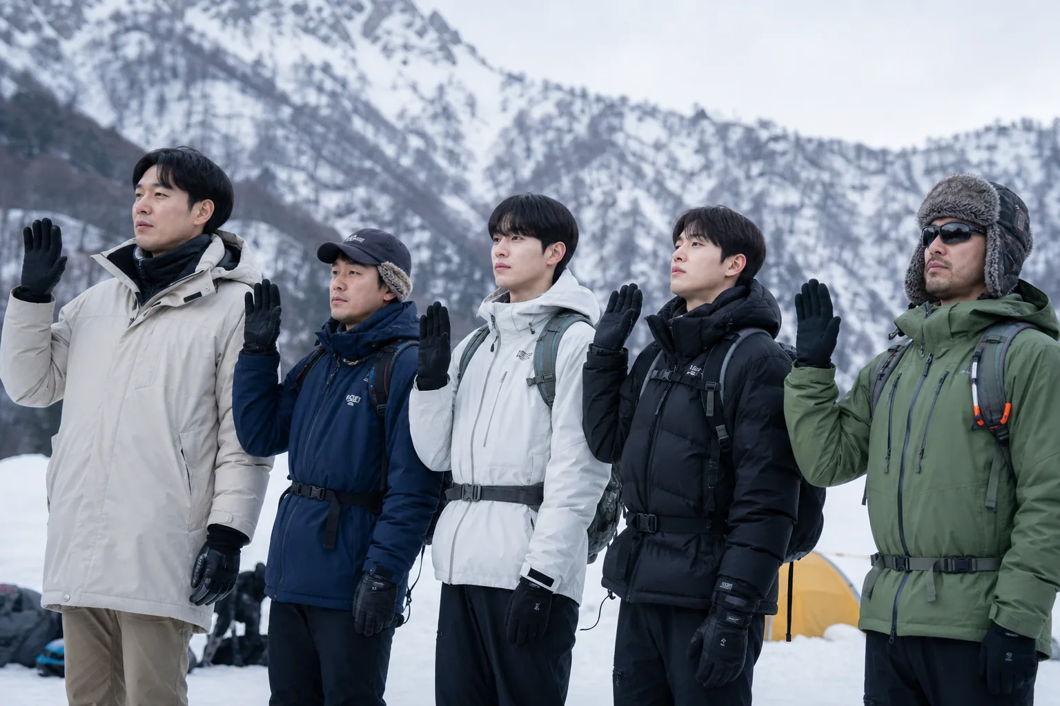 Four hikers preparing for a snowy mountain expedition