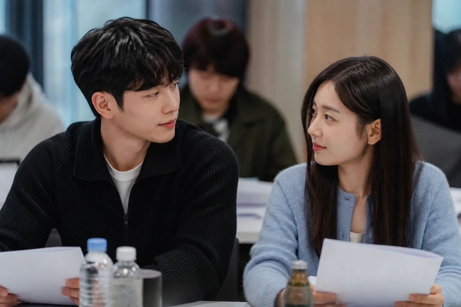 Korean drama actors at a script reading table