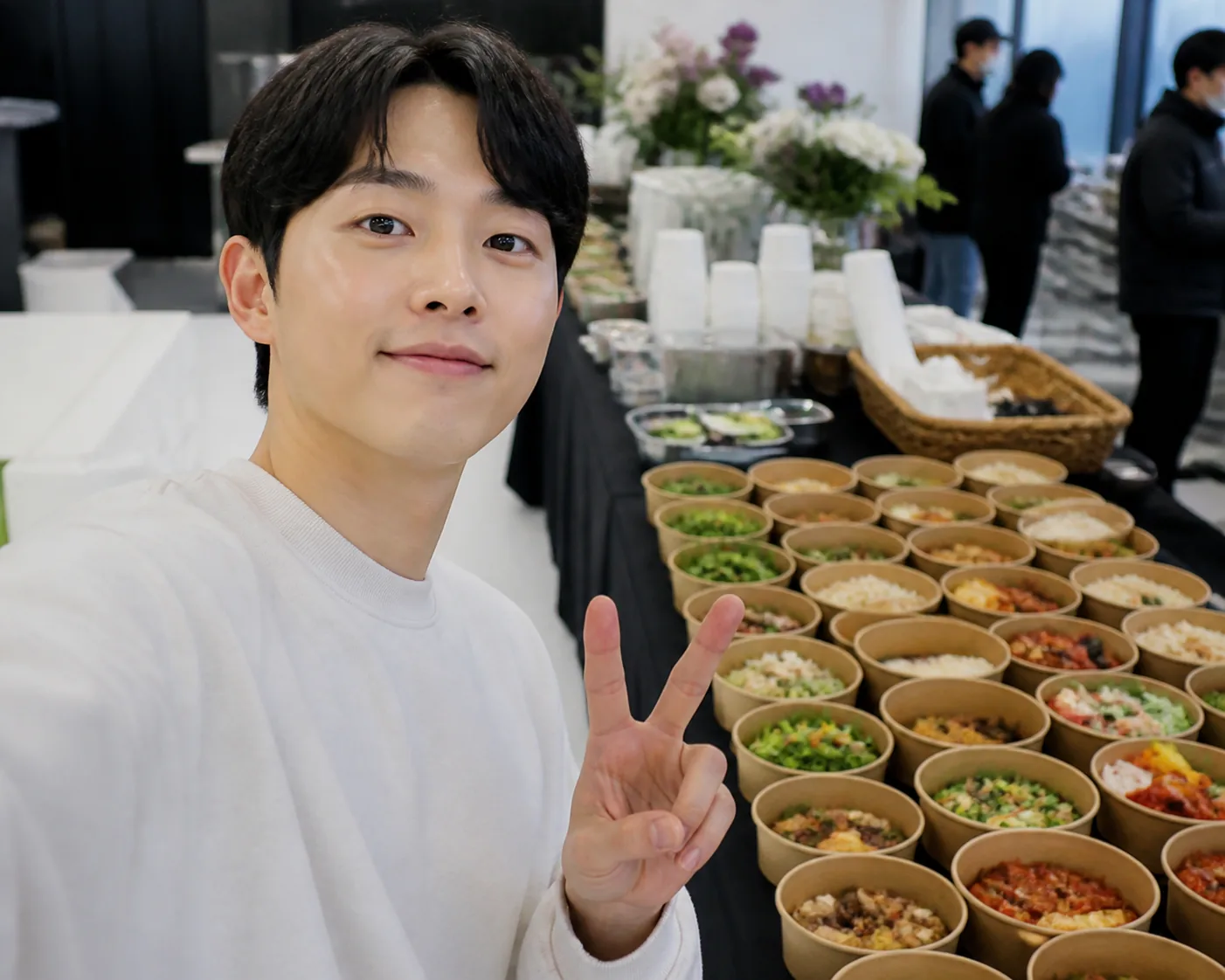 Editorial image of a Korean actor surrounded by a fan-support food display