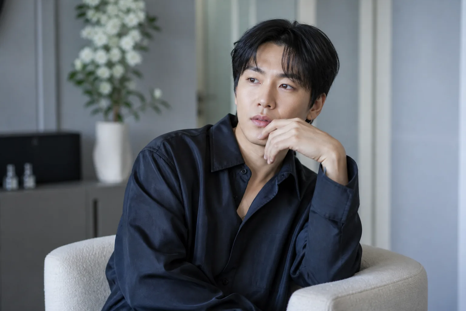 Korean R&B singer listening to a nostalgic playlist in a studio setting