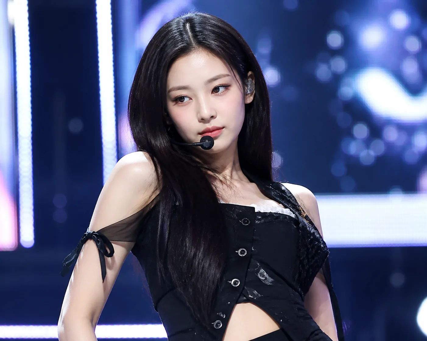 Modern K-pop broadcast stage prepared for a multi-artist performance lineup