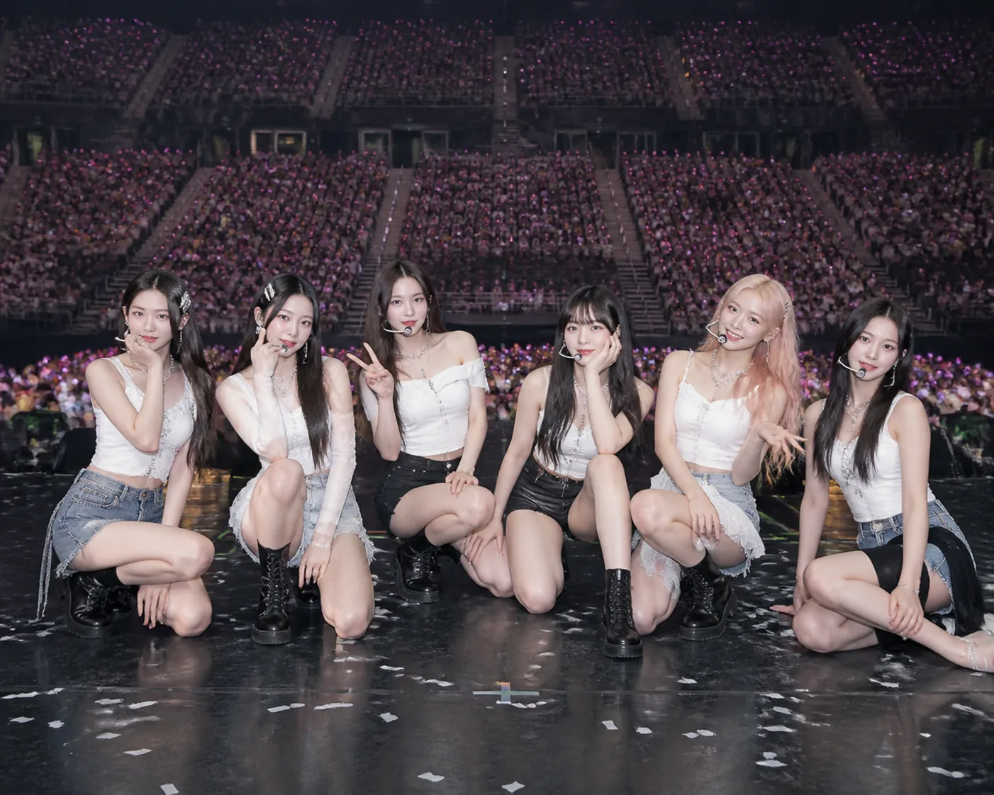 K-pop girl group performing together on a large arena stage
