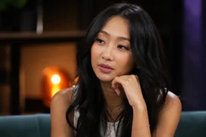 Editorial image representing a Korean pop artist in a relaxed studio interview setting