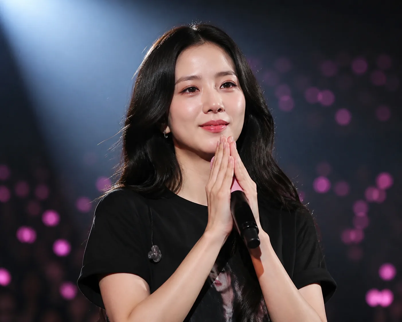 Editorial image of a handwritten message beside soft concert lightsticks