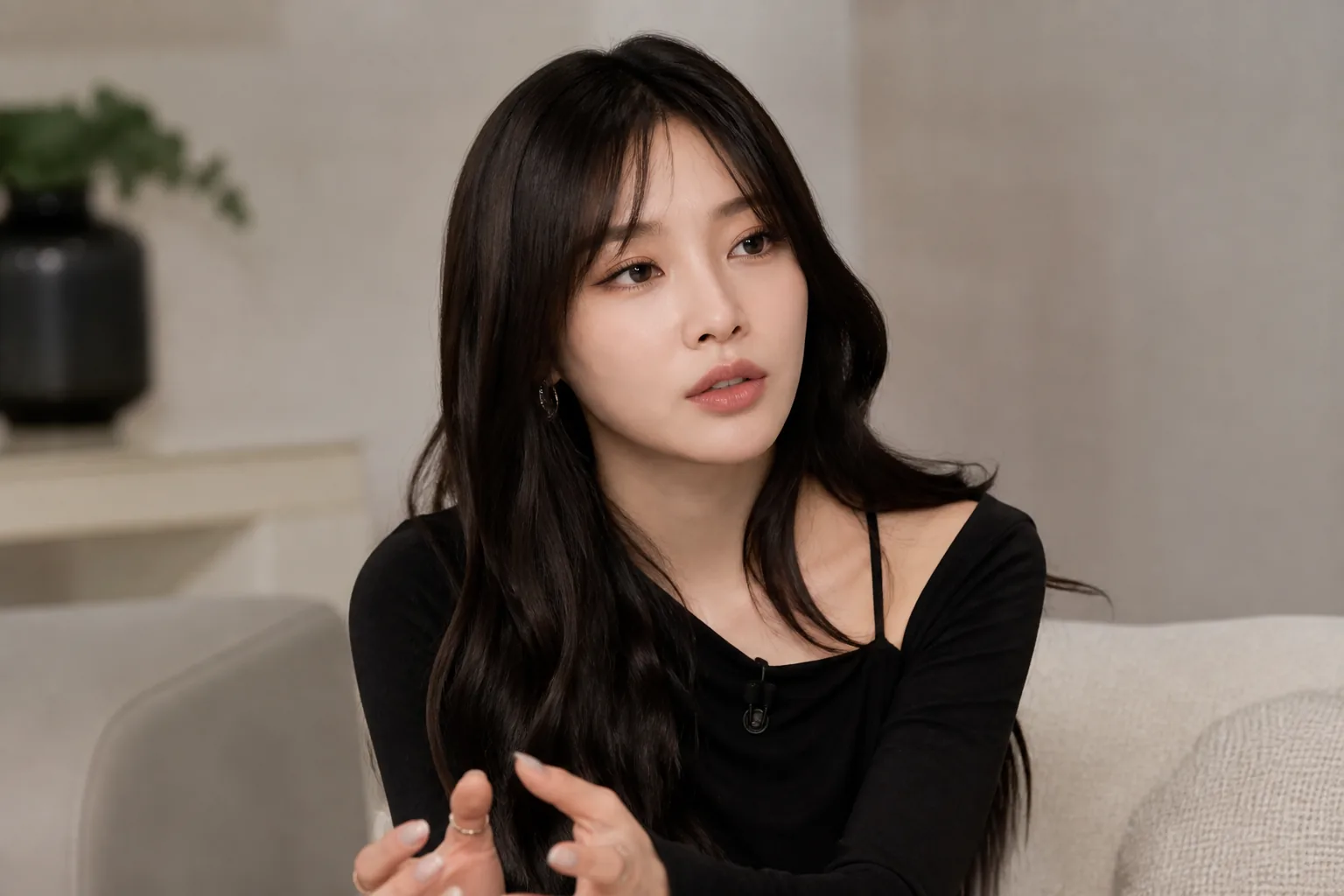 Editorial image of a Korean pop artist in a calm studio conversation
