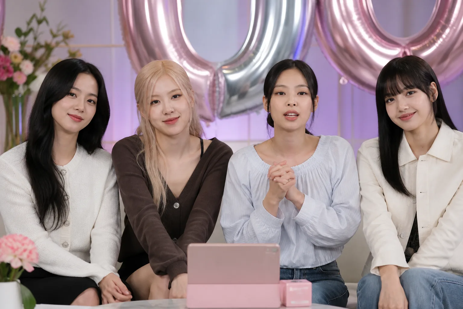 K-pop performers speaking together during an anniversary livestream