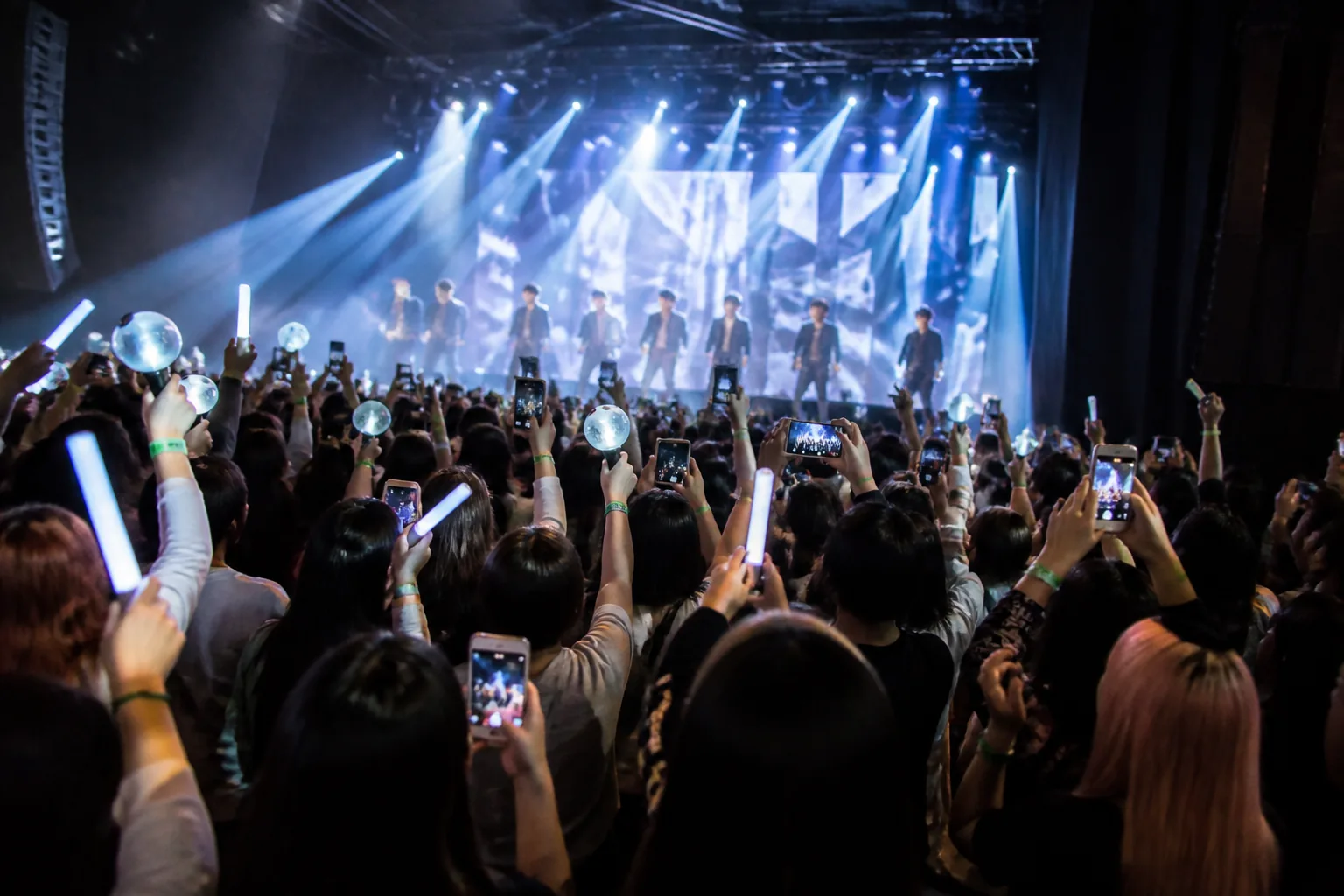 Fans arriving at a modern concert venue before a K-pop show
