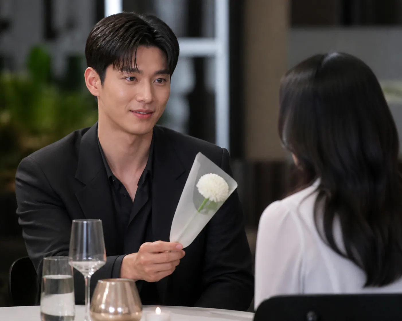 Prepared flower and notebook at a Korean television blind-date table
