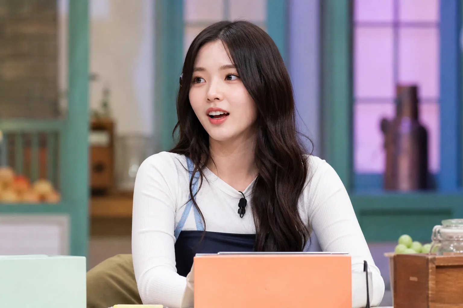 K-pop guests concentrating during a television game in a modern studio