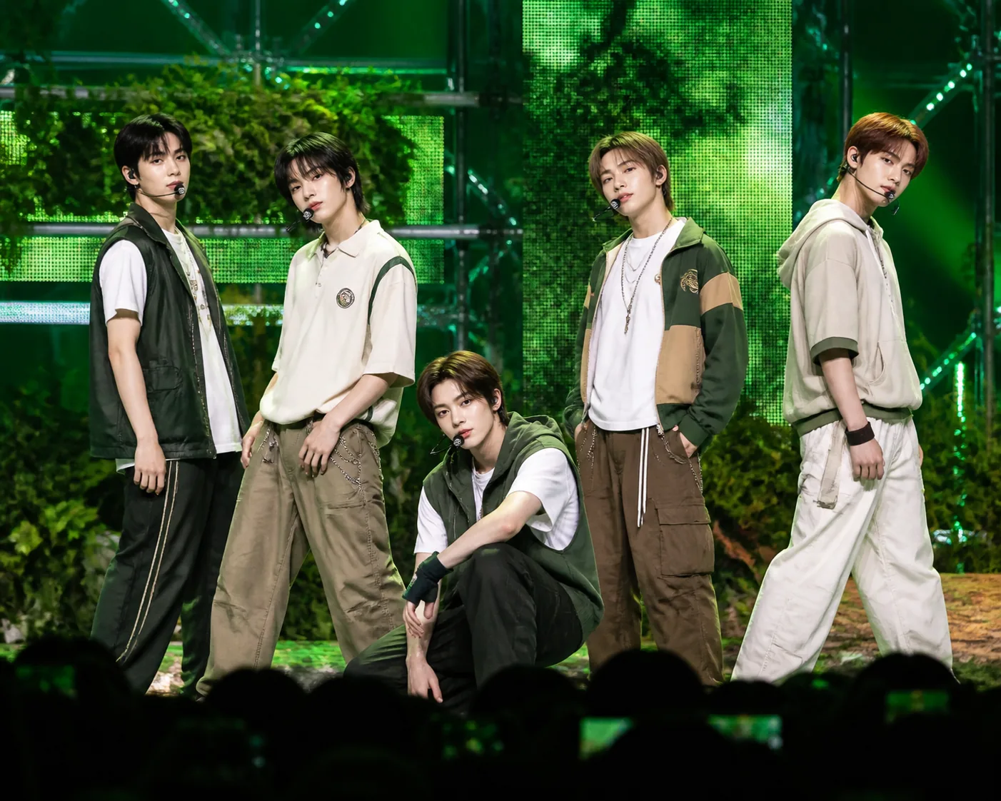 Green-lit concert stage representing the GREENGREEN album's chart rise