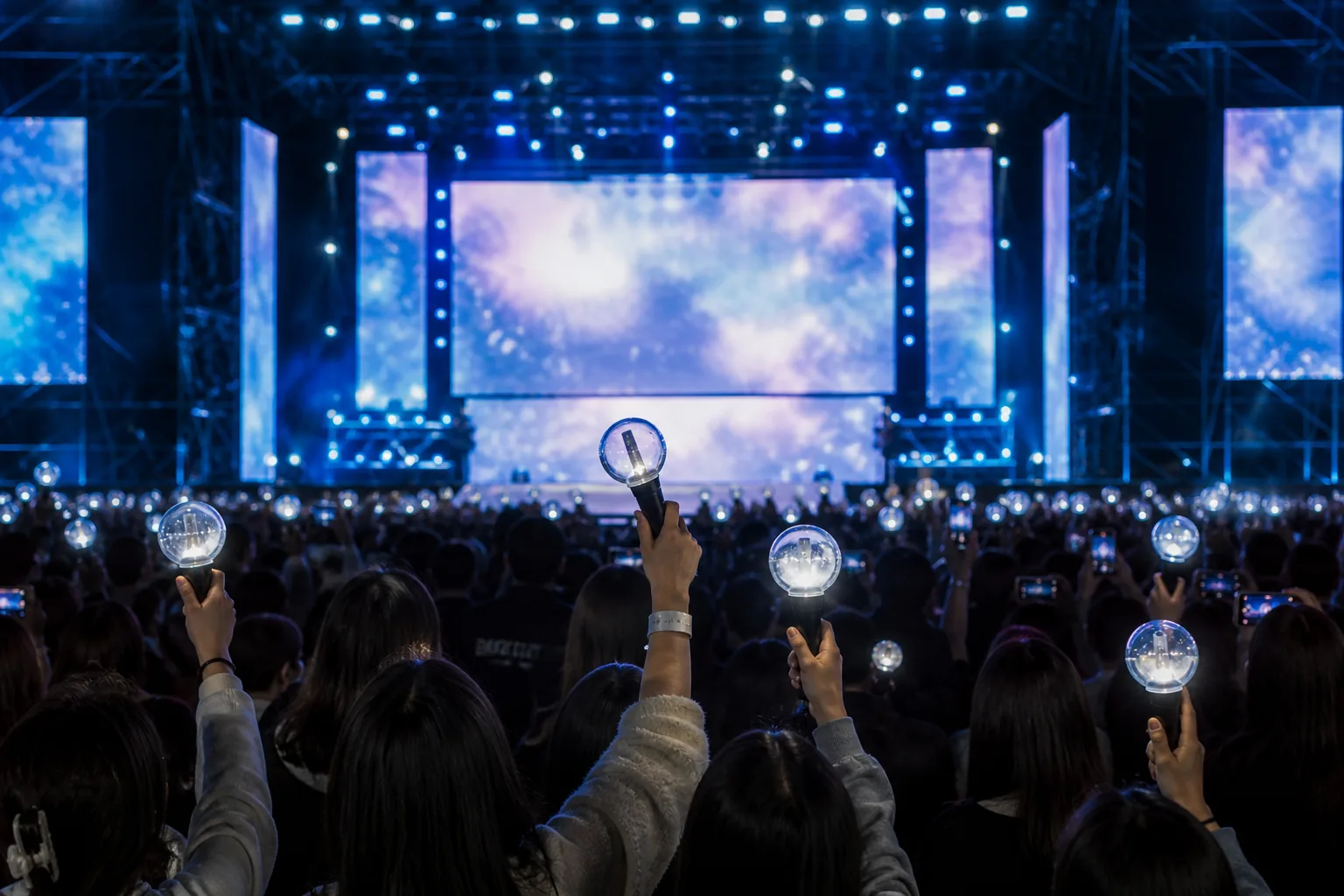Concertgoers checking schedule updates outside a European music festival venue
