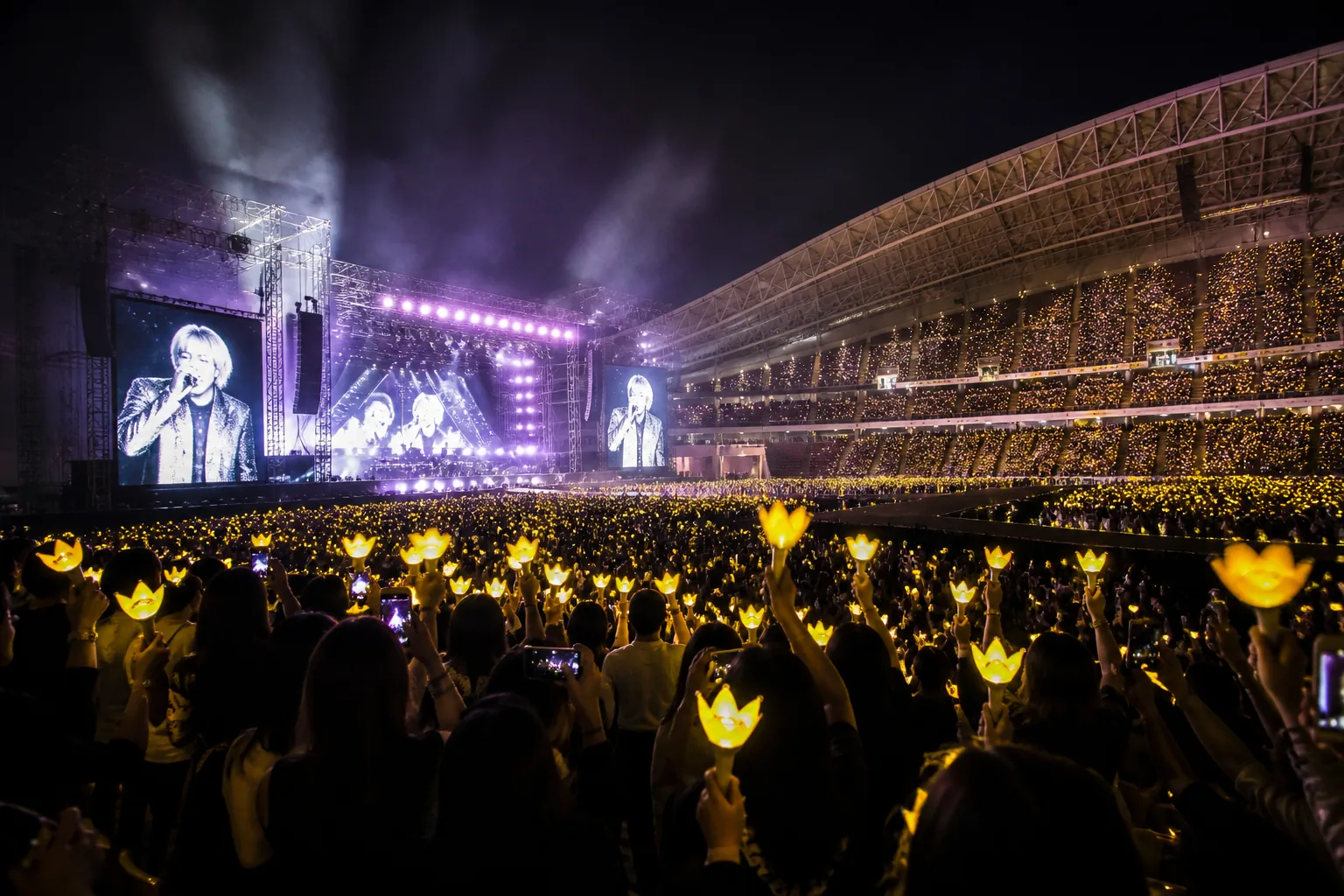 Three performers preparing for a large Singapore stadium concert