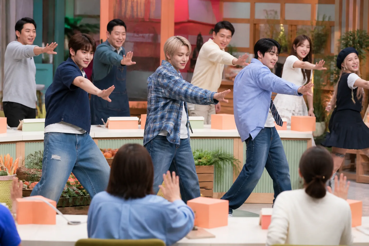 K-pop performers demonstrating comeback choreography in a television studio