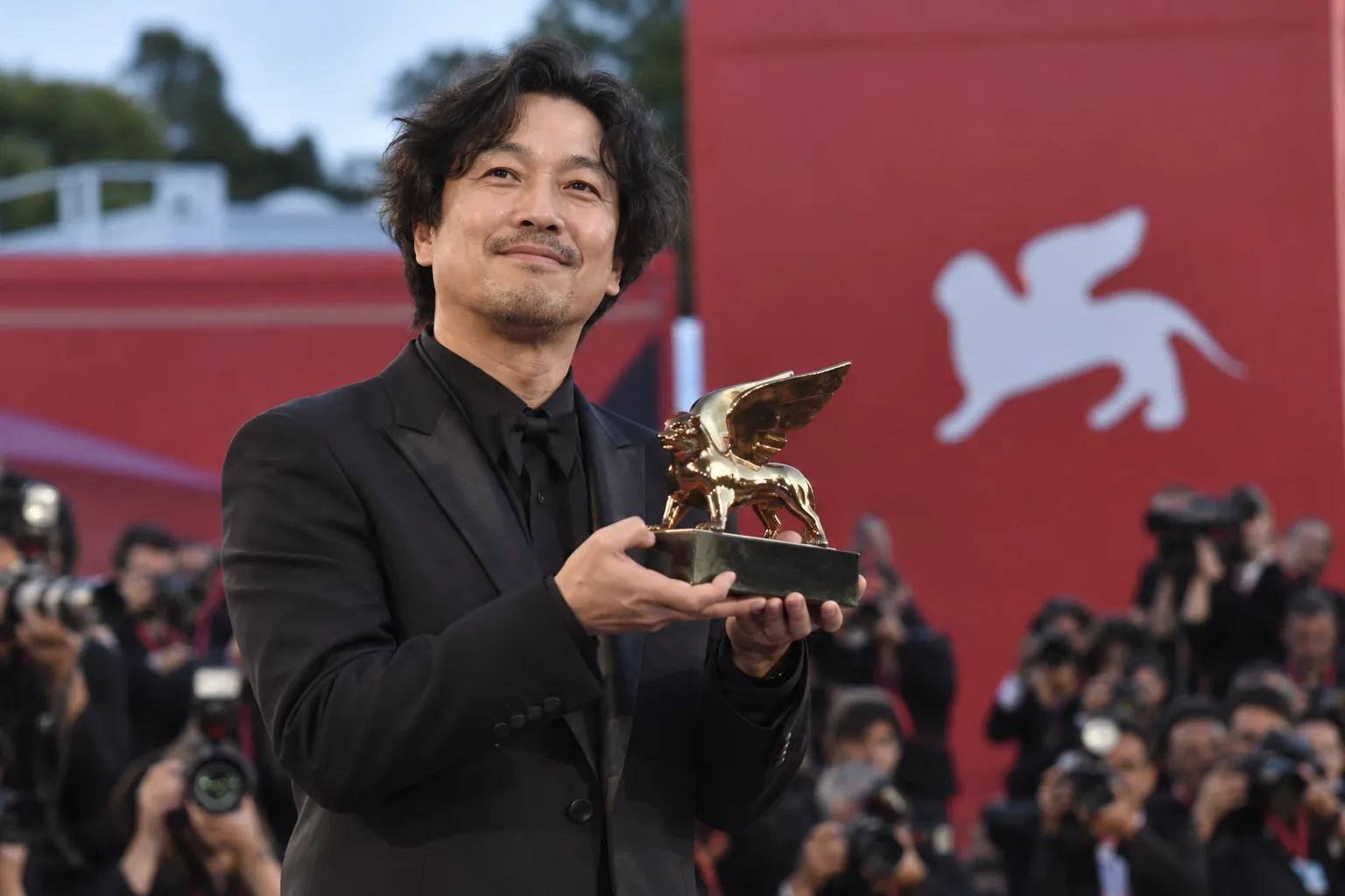 Cinema audience and silver award symbolizing Possible Love's Venice Film Festival honor