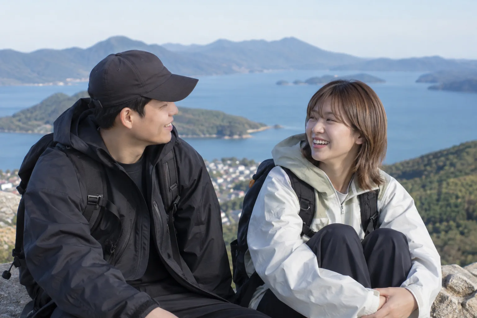 Two K-pop friends feeling both comfortable and awkward in front of travel cameras